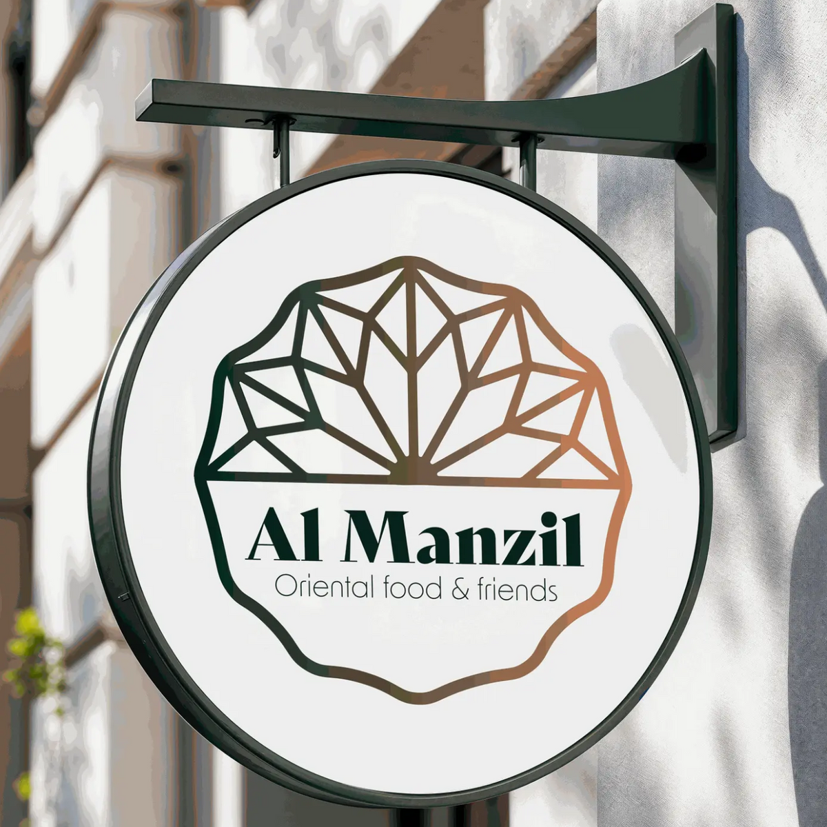 Round signboard for Al Manzil with geometric design on a building facade